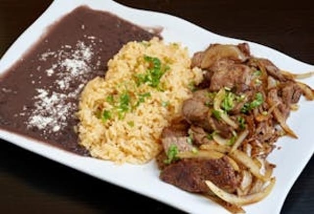 Bistec Encebollado (Sautéed Steak with Onions).